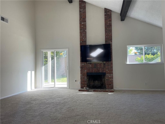 unfurnished living room with beam ceiling, a fireplace, high vaulted ceiling, and carpet flooring