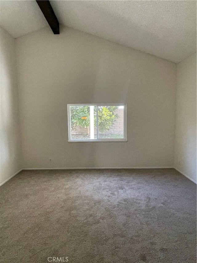 carpeted spare room featuring lofted ceiling with beams and a textured ceiling