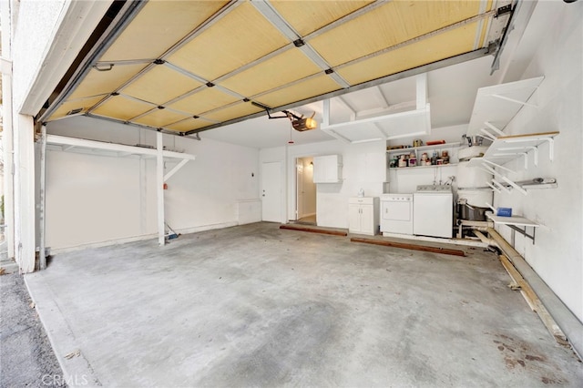 garage with washer and clothes dryer and a garage door opener