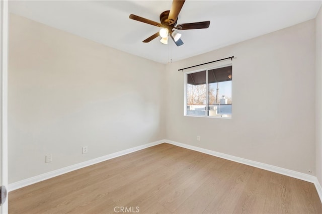 spare room featuring light wood-type flooring and ceiling fan