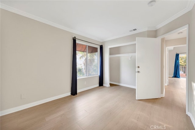 unfurnished bedroom featuring a closet, light hardwood / wood-style flooring, and ornamental molding