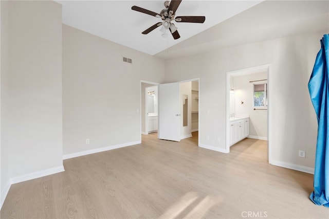 unfurnished bedroom featuring ensuite bath, ceiling fan, light hardwood / wood-style floors, and lofted ceiling