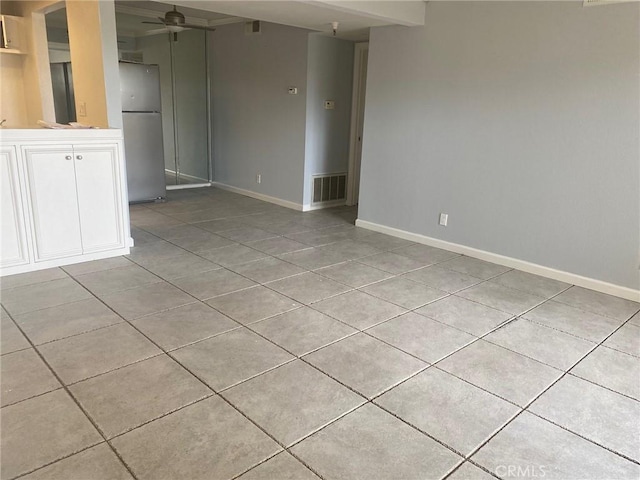 unfurnished room with ceiling fan and light tile patterned floors