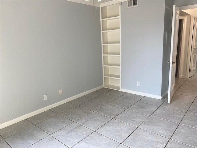 unfurnished room with light tile patterned floors