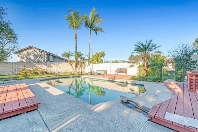 view of swimming pool featuring a wooden deck