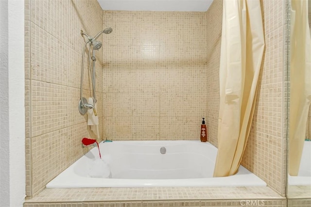 bathroom featuring shower / bathtub combination with curtain