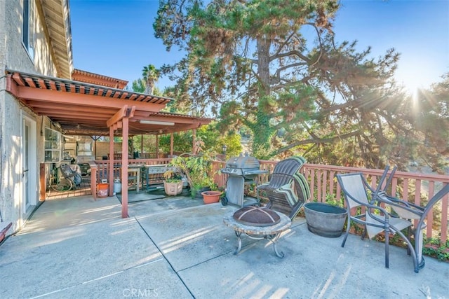 view of patio / terrace featuring a grill and a fire pit