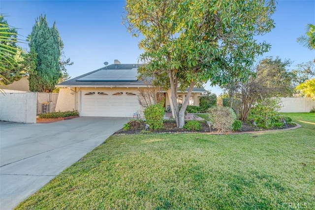 view of front of house featuring solar panels, a garage, and a front lawn