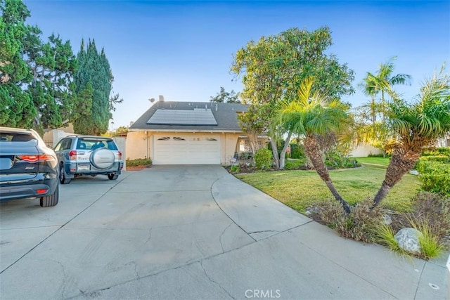 ranch-style home with solar panels and a front lawn