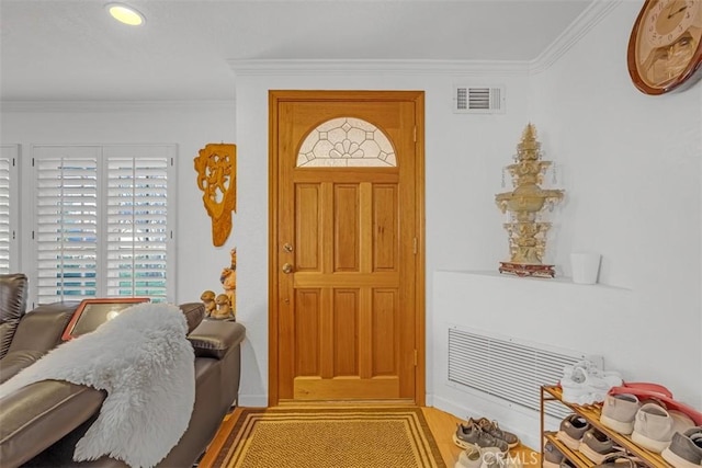 entryway featuring crown molding