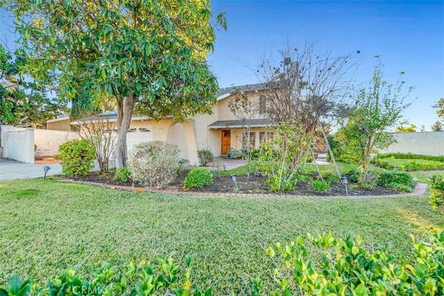 obstructed view of property featuring a front yard and a garage