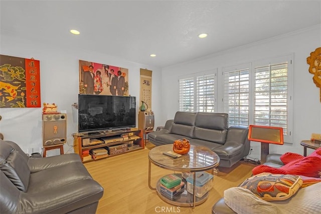 living room with ornamental molding, a healthy amount of sunlight, and hardwood / wood-style flooring