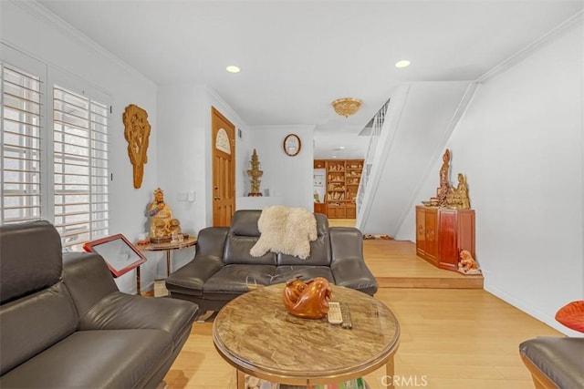 living room featuring light hardwood / wood-style floors and ornamental molding