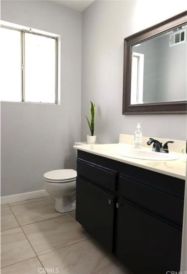 bathroom featuring tile patterned flooring, vanity, and toilet