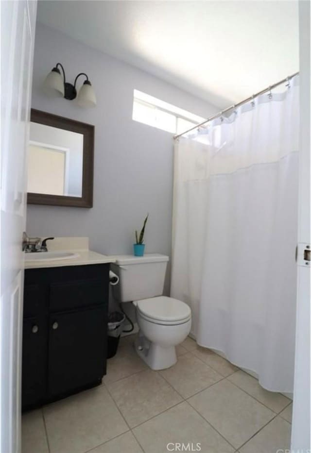 bathroom with vanity, tile patterned floors, and toilet