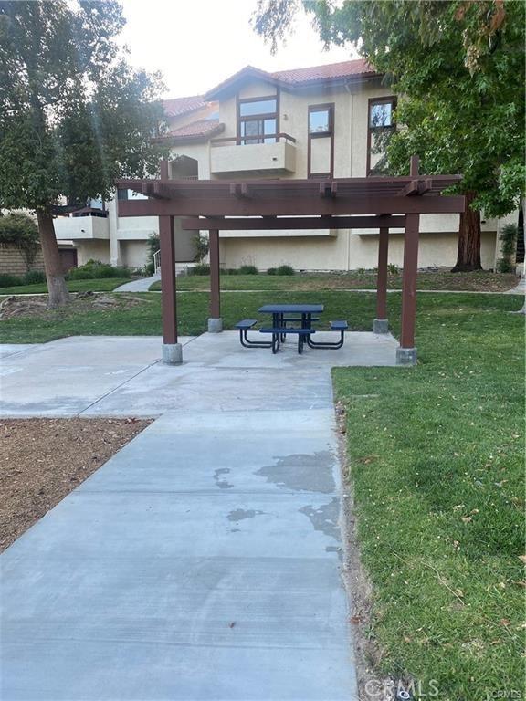 view of community with a lawn and a patio