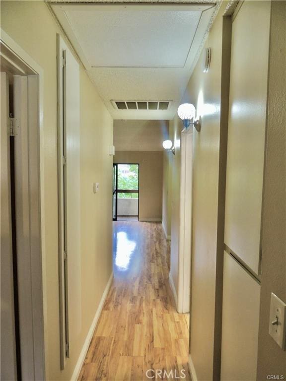 corridor with light wood-type flooring