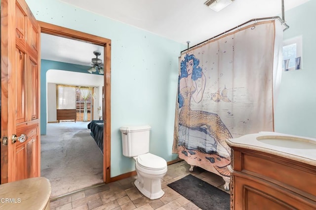 bathroom featuring toilet, vanity, ceiling fan, and a shower with curtain