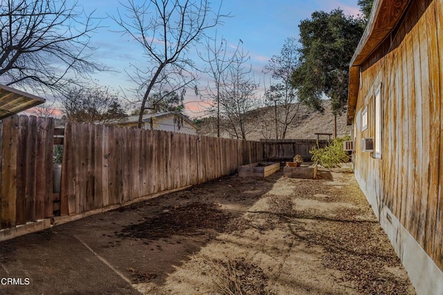 yard at dusk featuring cooling unit