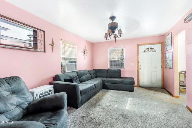 living room featuring an inviting chandelier, cooling unit, and light carpet