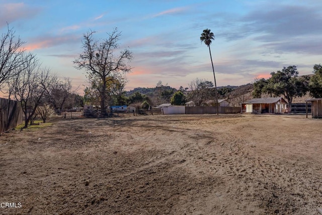 yard at dusk with a storage shed