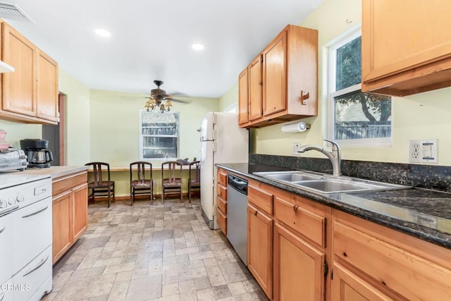 kitchen with stainless steel dishwasher, range, dark stone countertops, ceiling fan, and sink