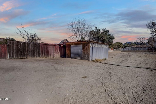 view of garage at dusk