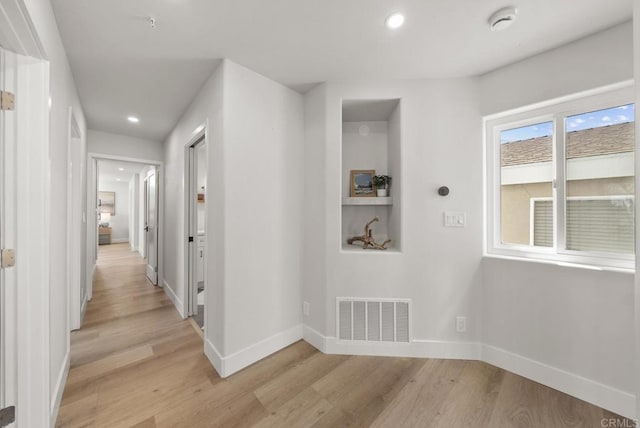 corridor featuring light hardwood / wood-style floors