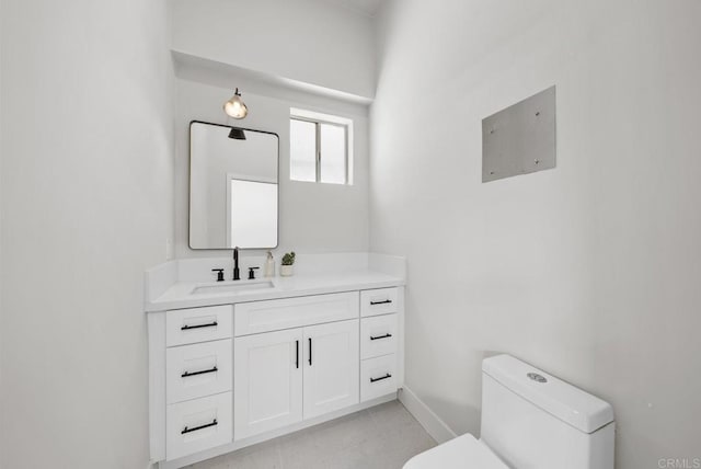 bathroom with tile patterned flooring, vanity, and toilet