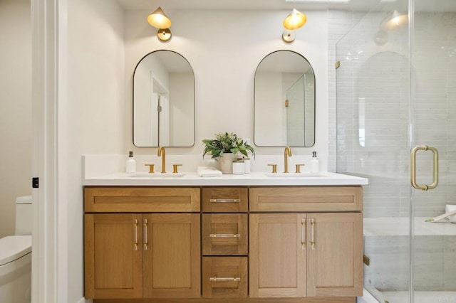 bathroom featuring vanity, toilet, and walk in shower