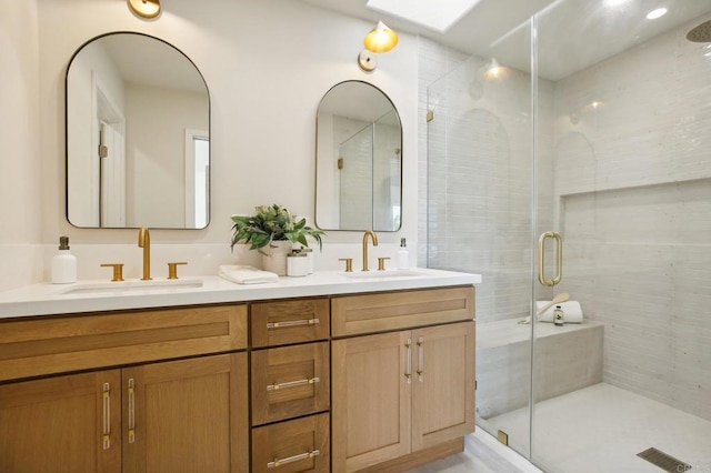 bathroom with vanity and a shower with shower door