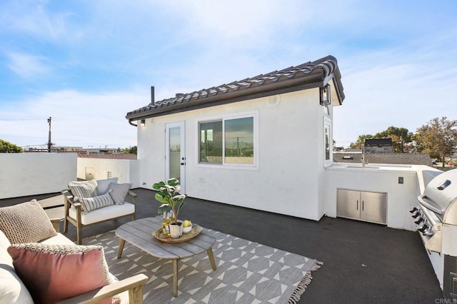 view of patio with outdoor lounge area and exterior kitchen