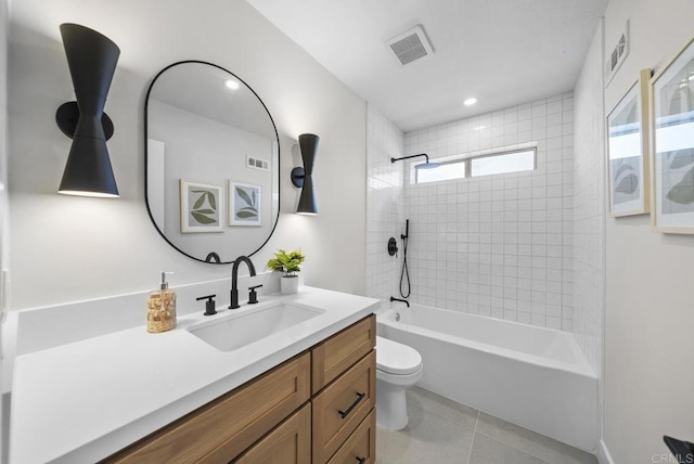 full bathroom featuring tile patterned floors, vanity, toilet, and tiled shower / bath combo