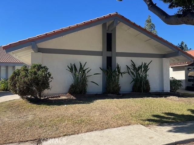 view of side of property with a lawn