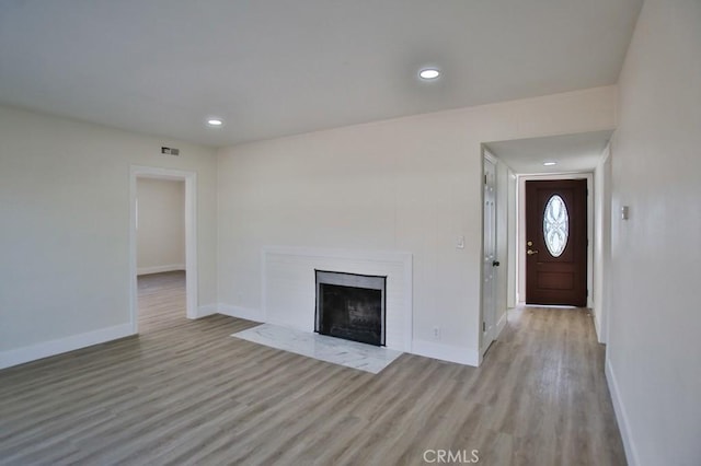 unfurnished living room featuring light hardwood / wood-style flooring