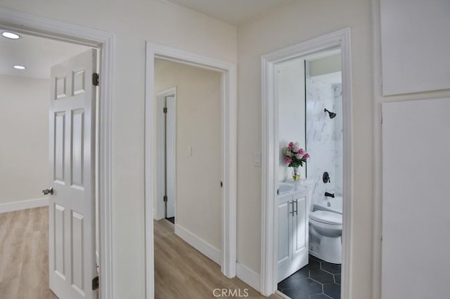 corridor with light hardwood / wood-style flooring