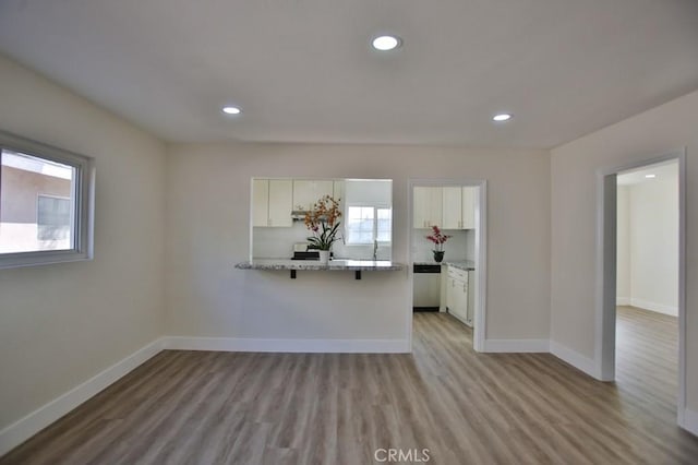 unfurnished living room with light hardwood / wood-style flooring