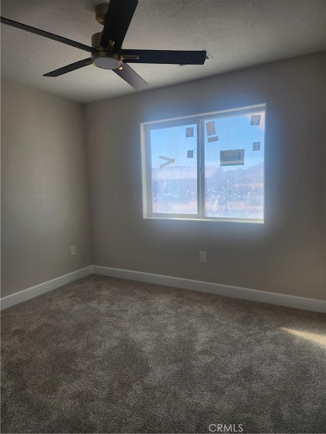 empty room featuring carpet floors and ceiling fan