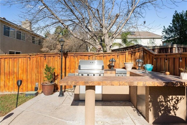 view of patio / terrace featuring an outdoor kitchen and area for grilling