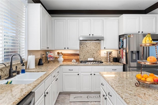 kitchen with sink, stainless steel appliances, white cabinetry, tasteful backsplash, and crown molding