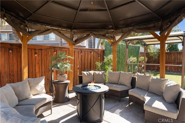 view of patio / terrace featuring an outdoor living space with a fire pit