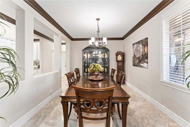 dining room featuring a notable chandelier and crown molding