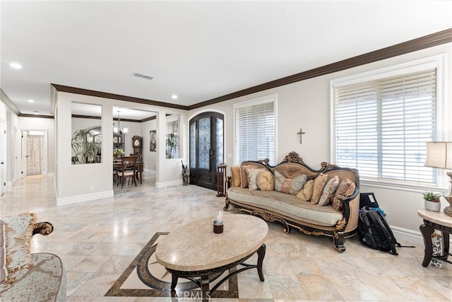 living room with an inviting chandelier and ornamental molding