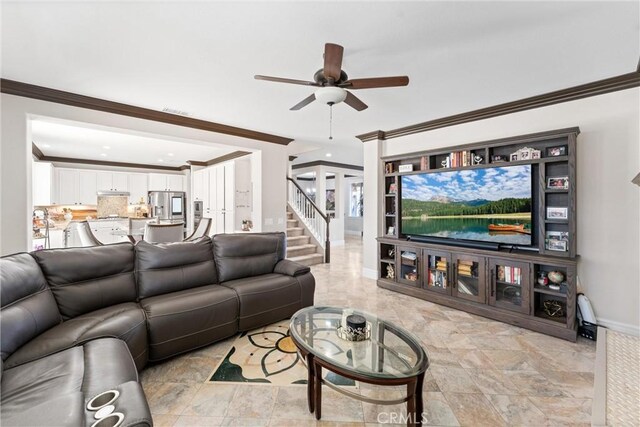 living room featuring ceiling fan and crown molding