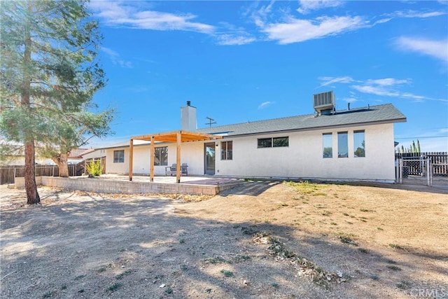 rear view of property featuring central AC unit and a patio