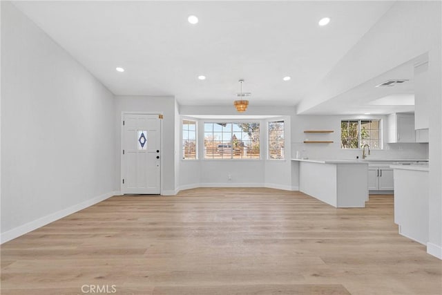 interior space with sink and light hardwood / wood-style floors