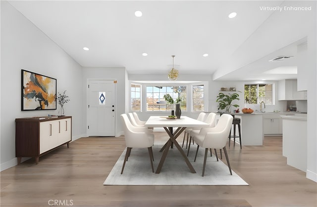 dining space featuring light hardwood / wood-style floors and sink