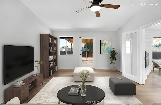 living room with vaulted ceiling, ceiling fan, and light hardwood / wood-style flooring