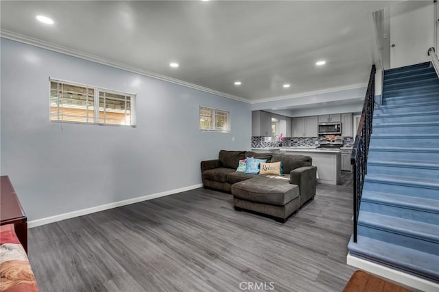 living room featuring hardwood / wood-style flooring and ornamental molding