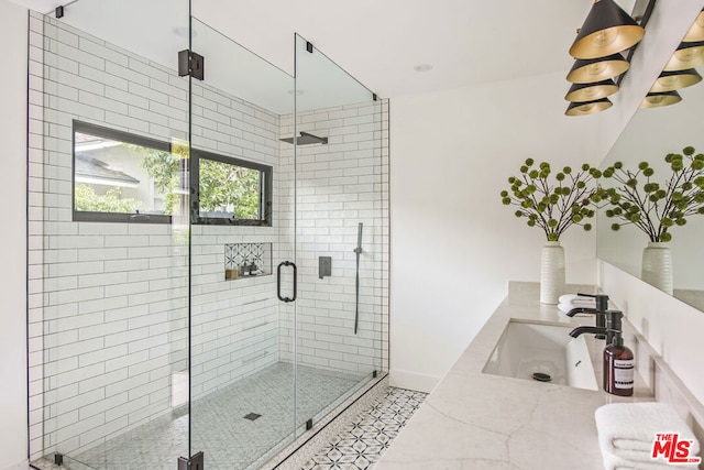 bathroom featuring vanity and a shower with shower door